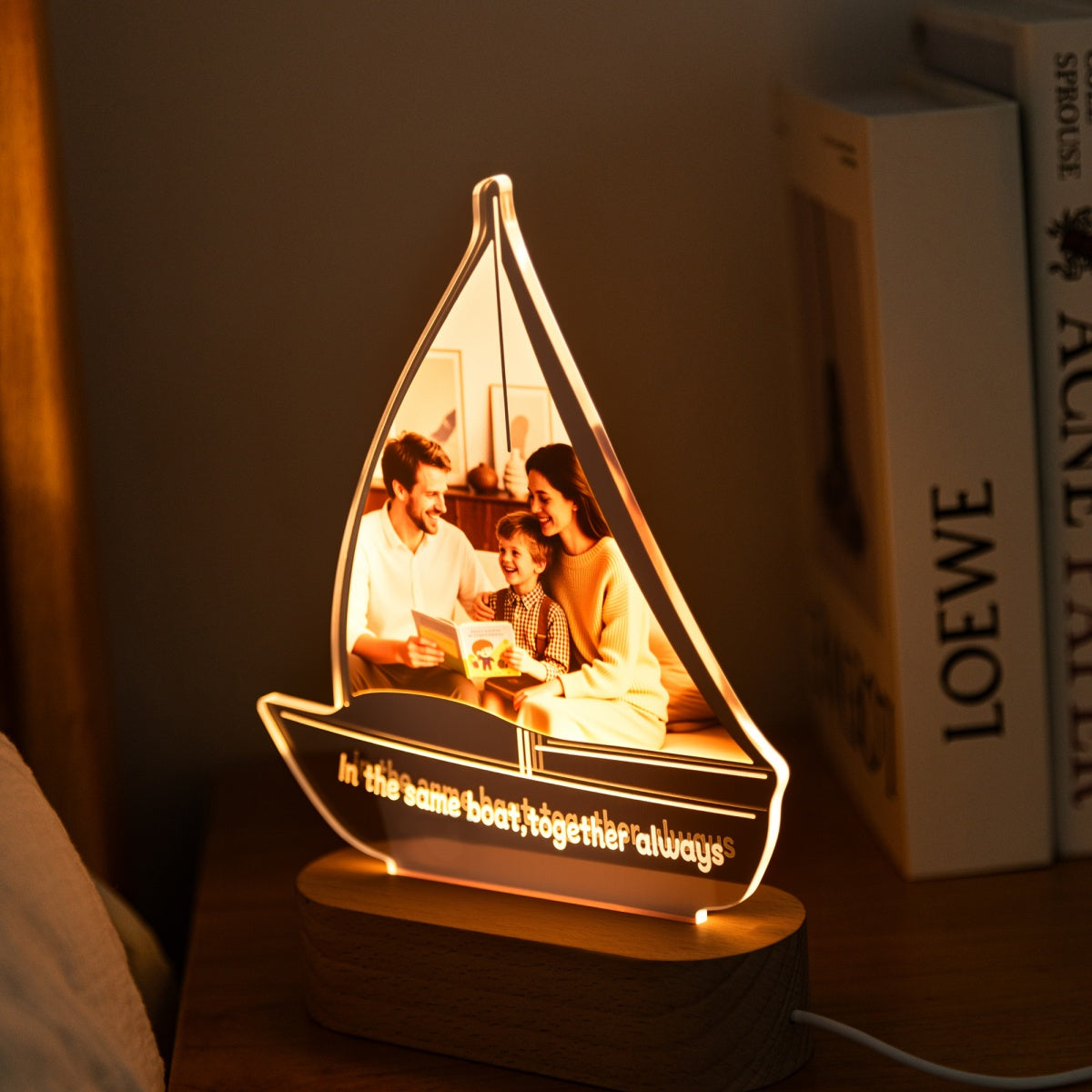 Personalized sailboat photo lamp on wooden base, glowing softly in bedroom – MoeCraze